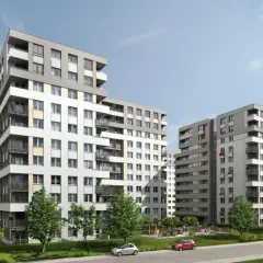 Nowoczesne budynki mieszkalne na osiedlu Avia Kraków. Zieleń, chodniki i samochody tworzą przyjazną przestrzeń.