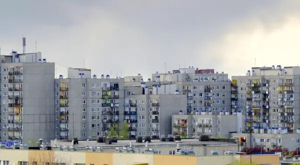 Szare bloki mieszkalne, typowe dla osiedli z PRL-u. Zastanawiasz się, ile kosztuje wykup mieszkania komunalnego w takim miejscu?